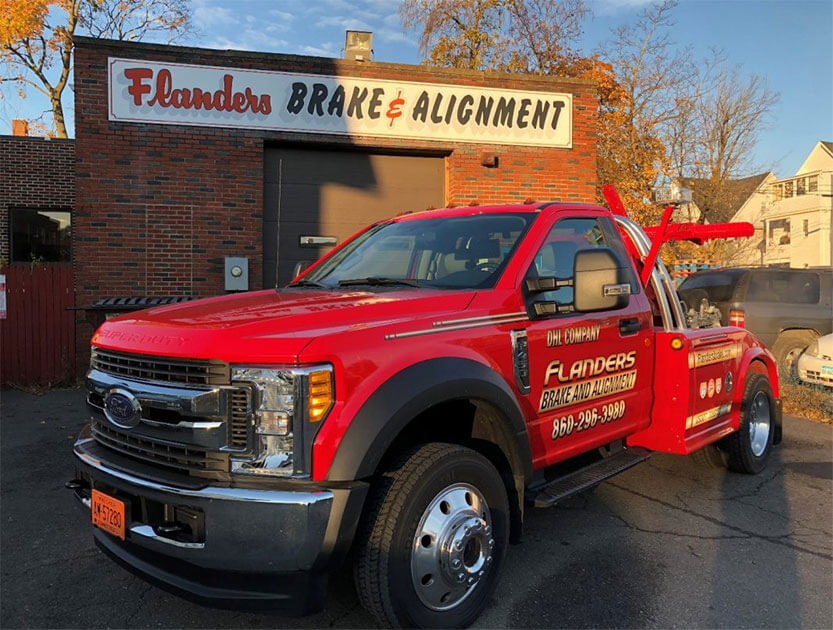 Flanders Brake & Alignment - Our Towing Truck in front of the building